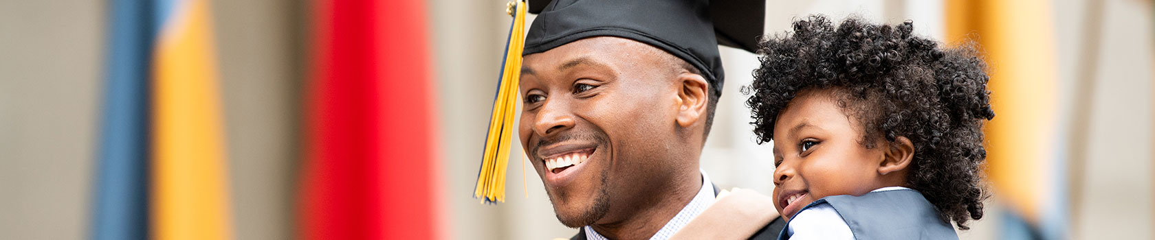 A man with a child at graduation