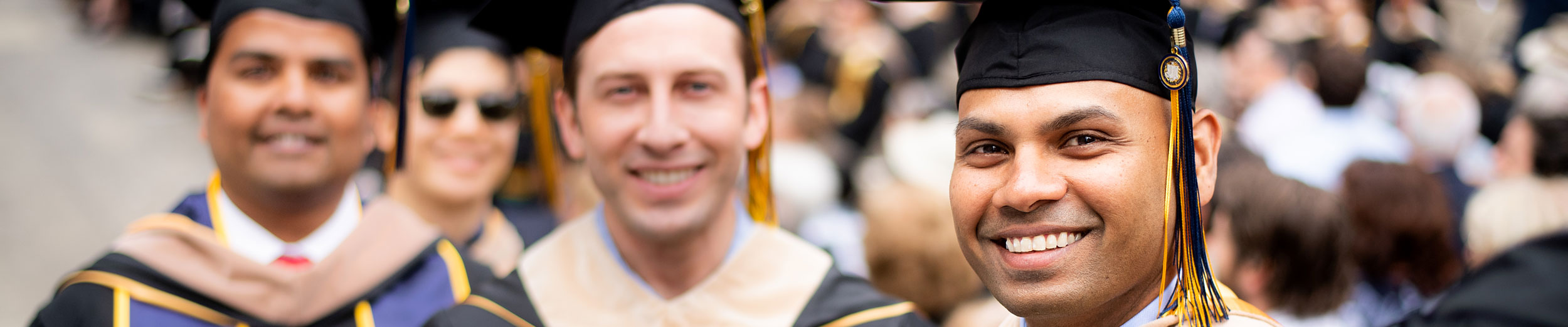 Men smiling at graduation