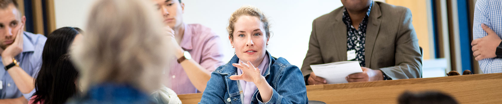 A female student speaking with her professor during class